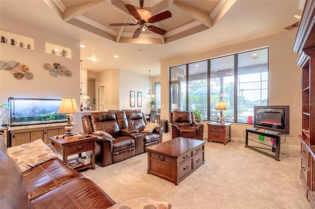 living room featuring ceiling fan, light colored carpet, ornamental molding, and coffered ceiling