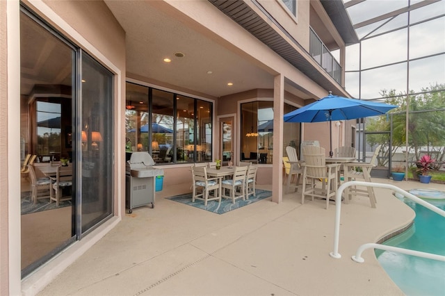 view of patio / terrace with area for grilling and glass enclosure