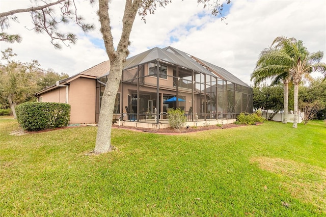 back of property with a lanai and a yard