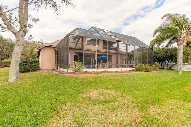 back of property featuring glass enclosure and a yard