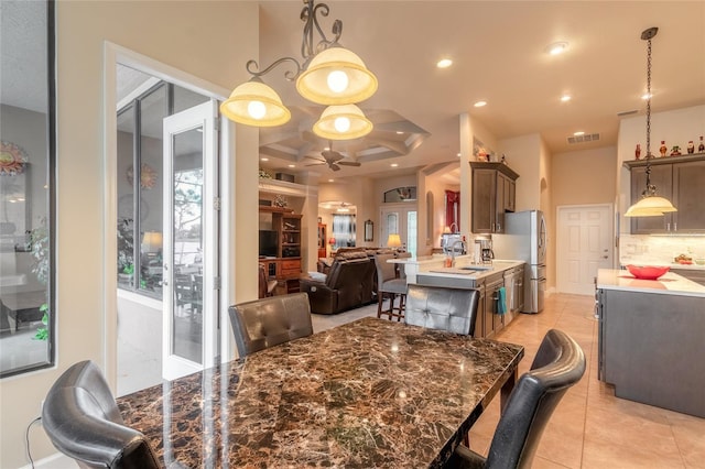 dining room with ceiling fan, sink, and light tile patterned floors