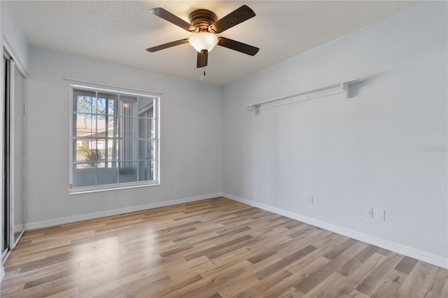 unfurnished room featuring a textured ceiling, ceiling fan, and light hardwood / wood-style floors