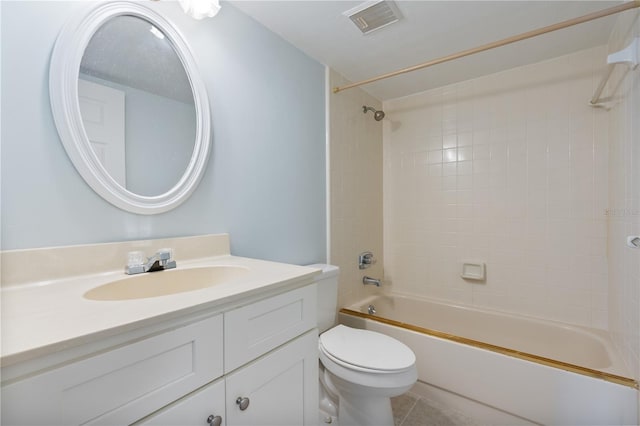 full bathroom featuring tile patterned flooring, toilet, vanity, and tiled shower / bath