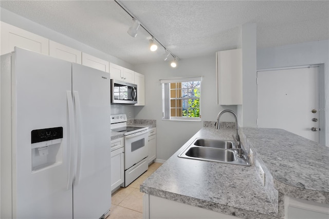 kitchen featuring white appliances, white cabinetry, a textured ceiling, and sink