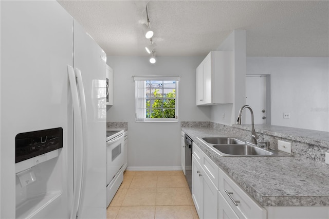 kitchen with white appliances, kitchen peninsula, sink, and white cabinetry