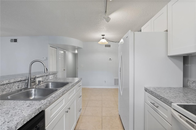 kitchen with white fridge, white cabinets, a textured ceiling, sink, and light tile patterned flooring