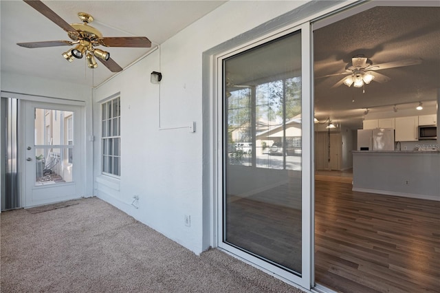 unfurnished sunroom featuring ceiling fan