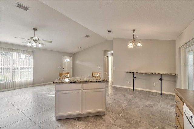 kitchen featuring white cabinetry, white dishwasher, pendant lighting, vaulted ceiling, and ceiling fan with notable chandelier