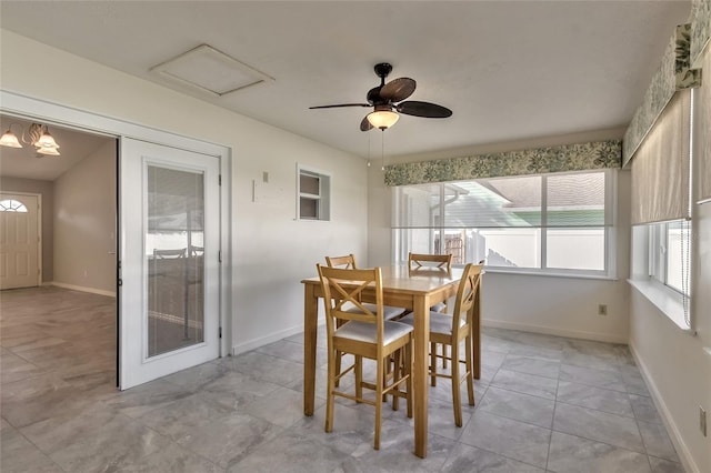 sunroom / solarium featuring ceiling fan