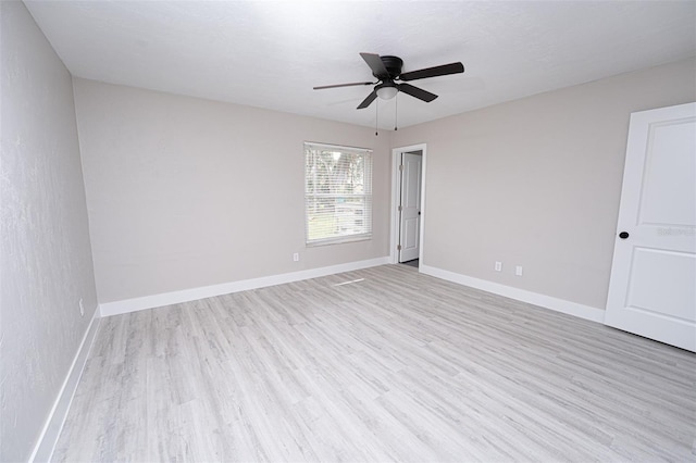 unfurnished room with light wood-style flooring, baseboards, and ceiling fan