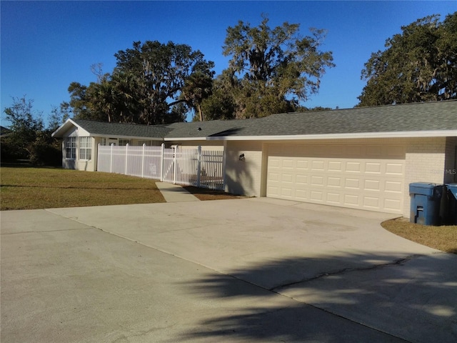 view of front of property featuring a garage and a front yard