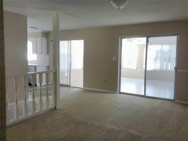 carpeted spare room with plenty of natural light