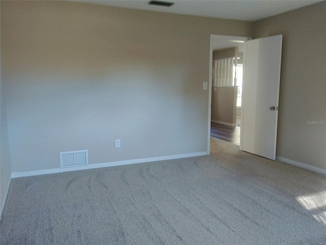 unfurnished room featuring light colored carpet