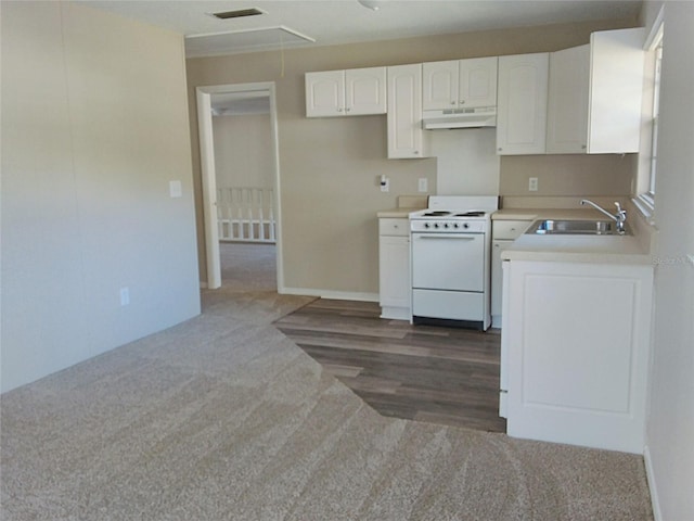 kitchen featuring white cabinets, white range oven, and sink