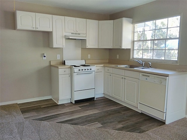 kitchen featuring white cabinetry, sink, a healthy amount of sunlight, and white appliances