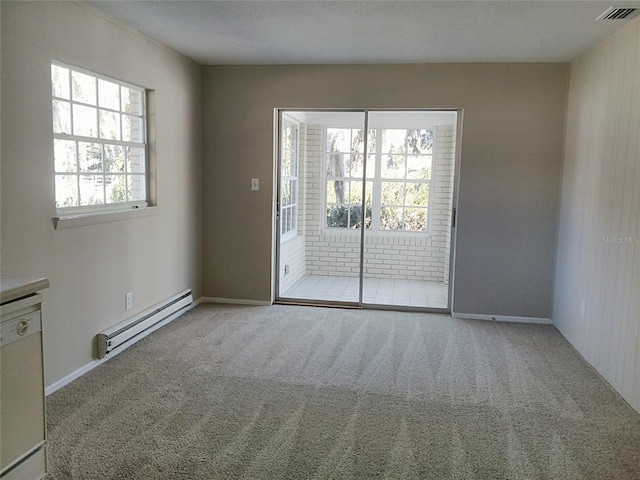 spare room featuring light colored carpet and a baseboard radiator