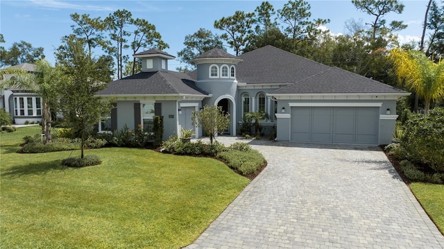 view of front of house with a garage and a front lawn