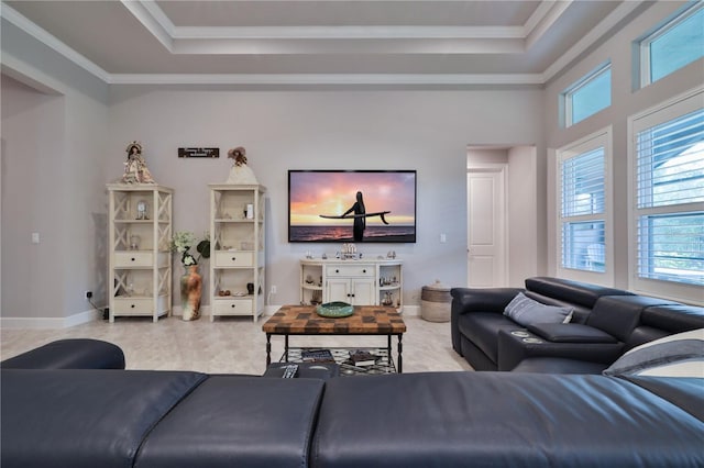 living room with a raised ceiling and ornamental molding