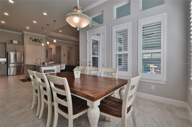 dining area with ornamental molding and sink