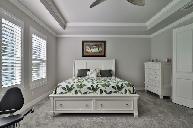 bedroom with ornamental molding, a tray ceiling, ceiling fan, and light colored carpet