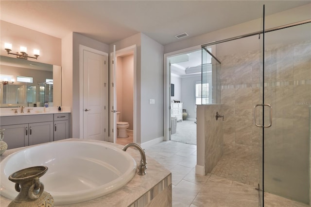 full bathroom with plus walk in shower, tile patterned floors, vanity, and toilet