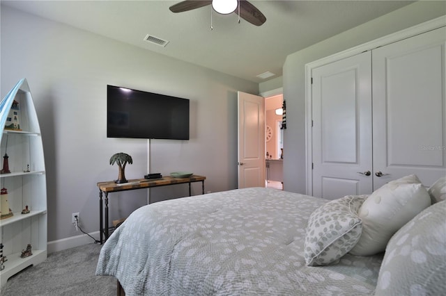 carpeted bedroom with ceiling fan and a closet