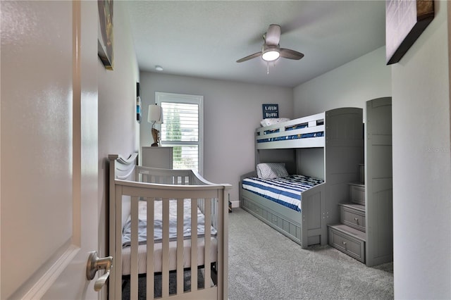 bedroom featuring ceiling fan and light colored carpet