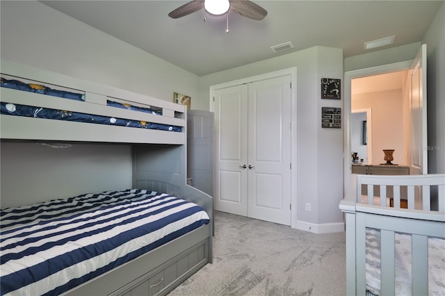 bedroom featuring a closet, ceiling fan, and light colored carpet