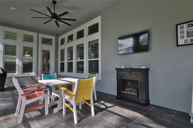 view of patio with ceiling fan and exterior fireplace