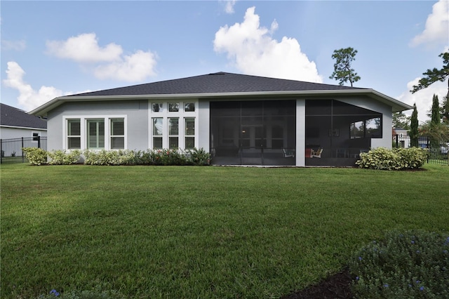 back of property featuring a sunroom and a yard