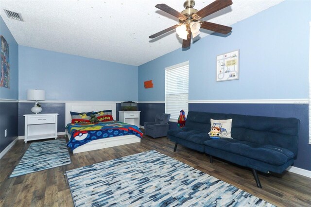 bedroom featuring baseboards, visible vents, lofted ceiling, ceiling fan, and wood finished floors