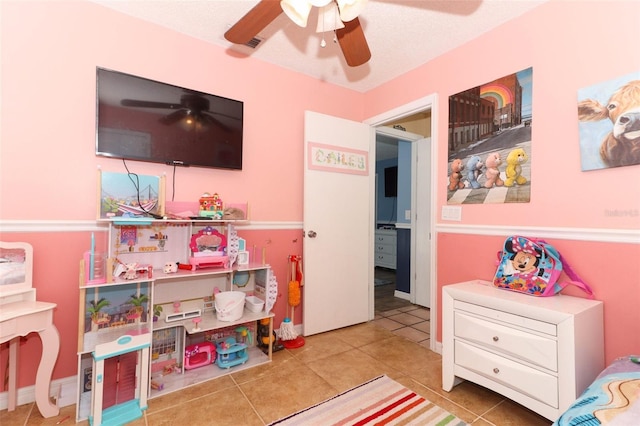 playroom featuring ceiling fan and tile patterned floors