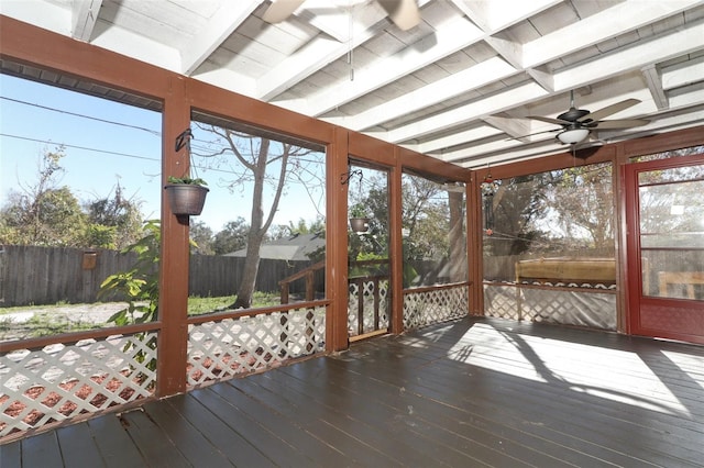 sunroom with beam ceiling and a ceiling fan