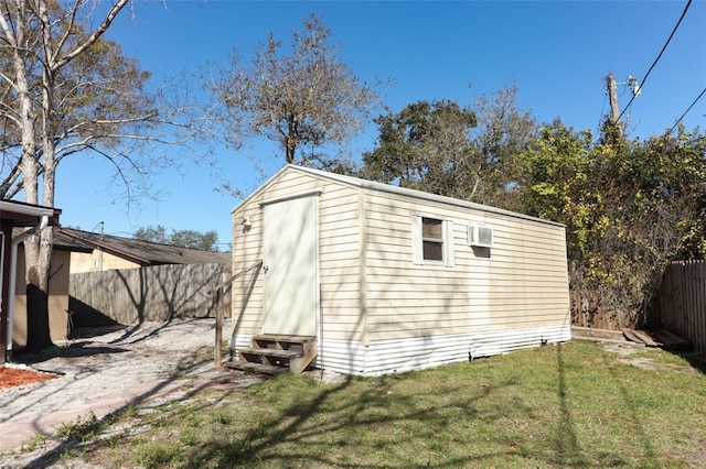 view of shed with entry steps and a fenced backyard