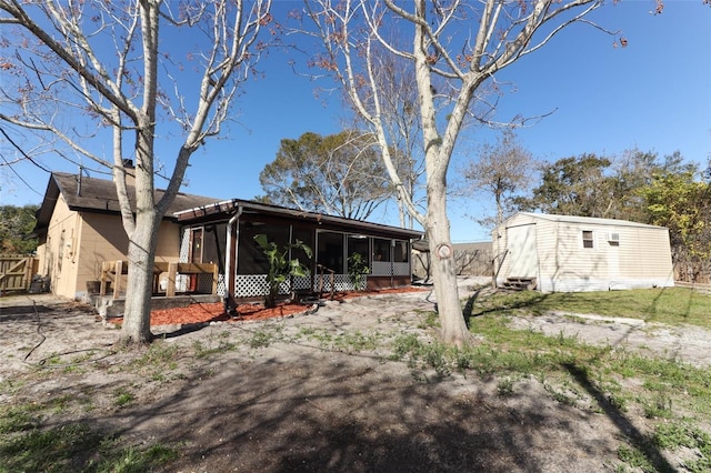 view of front facade with an outdoor structure and a sunroom