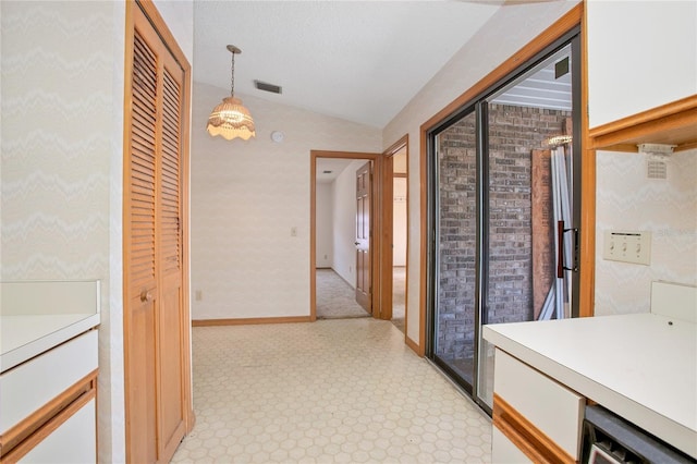 hallway featuring vaulted ceiling