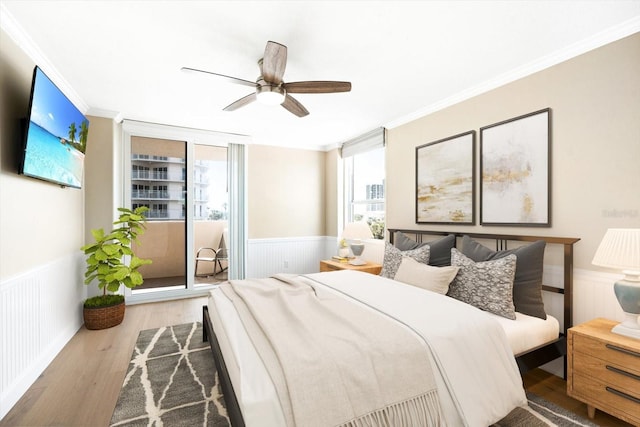 bedroom with light wood-type flooring, ceiling fan, ornamental molding, and multiple windows