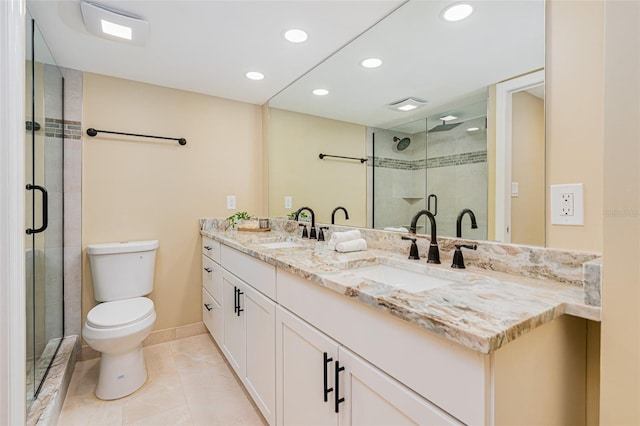 bathroom with a shower with shower door, tile patterned floors, toilet, and vanity