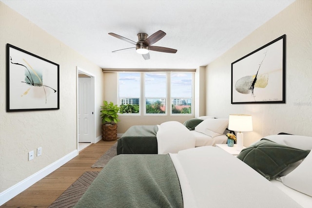 bedroom with ceiling fan and light hardwood / wood-style flooring