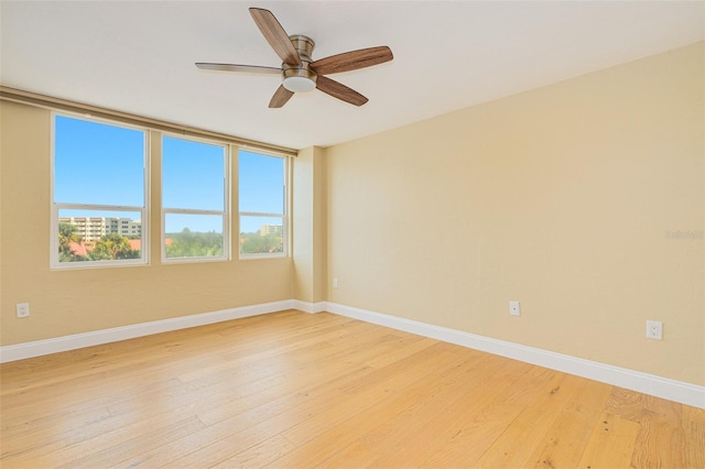 unfurnished room featuring ceiling fan and hardwood / wood-style floors