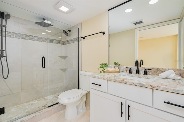 bathroom featuring toilet, tile patterned flooring, a shower with shower door, and vanity