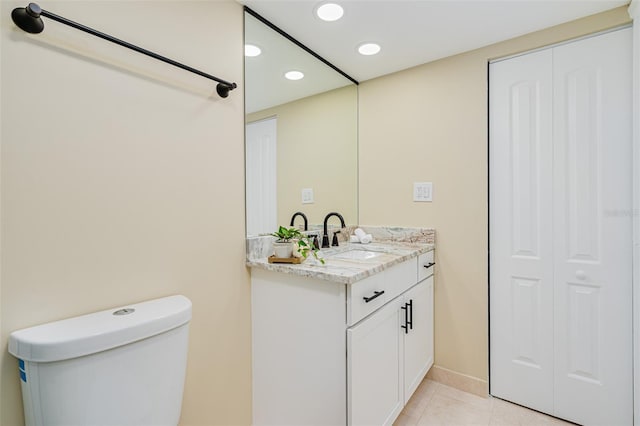 bathroom featuring toilet, tile patterned flooring, and vanity