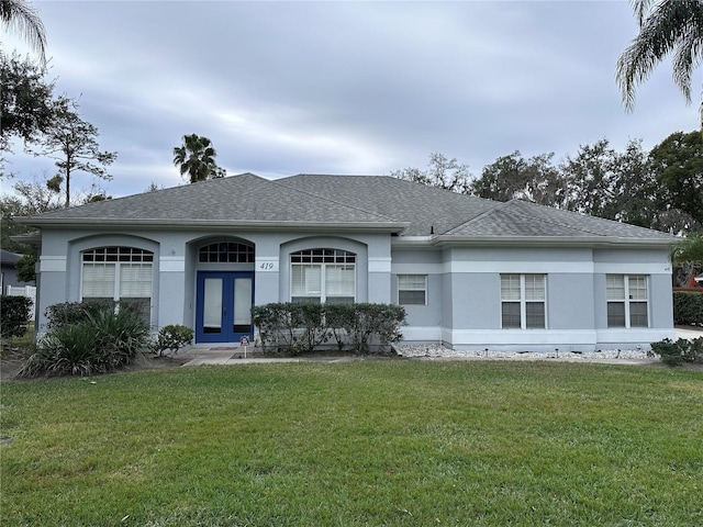 ranch-style home featuring a front yard and french doors