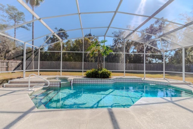 view of pool with a patio, a fenced backyard, a lanai, and a pool with connected hot tub