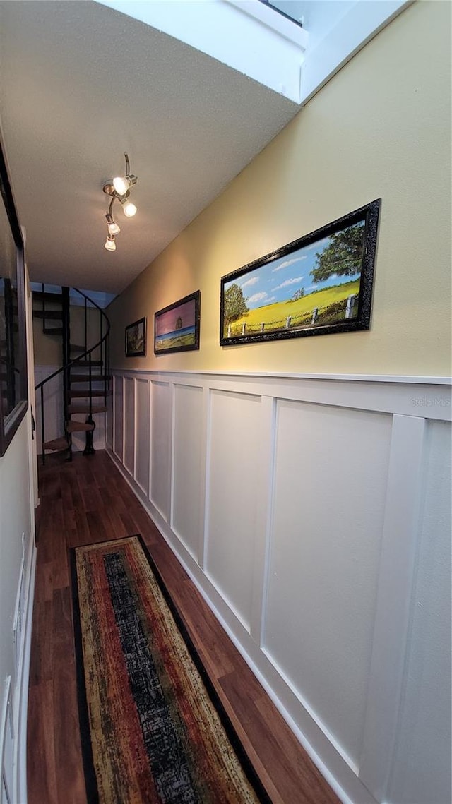 corridor with dark wood-type flooring and a skylight