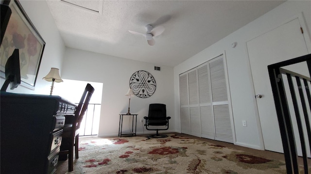 office space featuring a textured ceiling, ceiling fan, and carpet floors