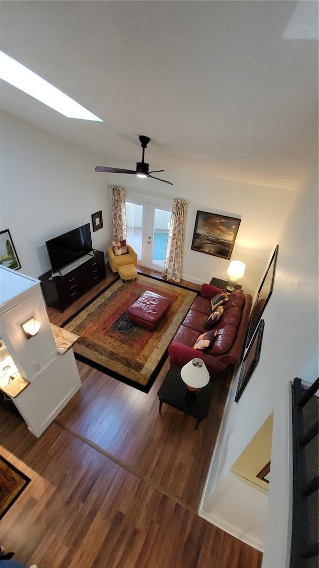 living room with ceiling fan, french doors, and hardwood / wood-style floors