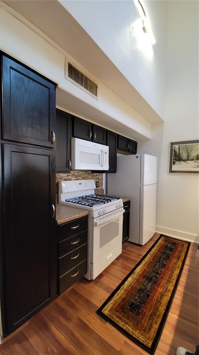 kitchen featuring white appliances and hardwood / wood-style flooring