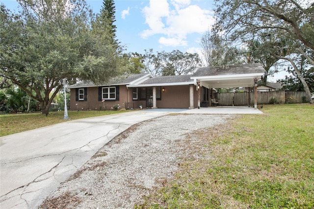 single story home with a front yard and a carport