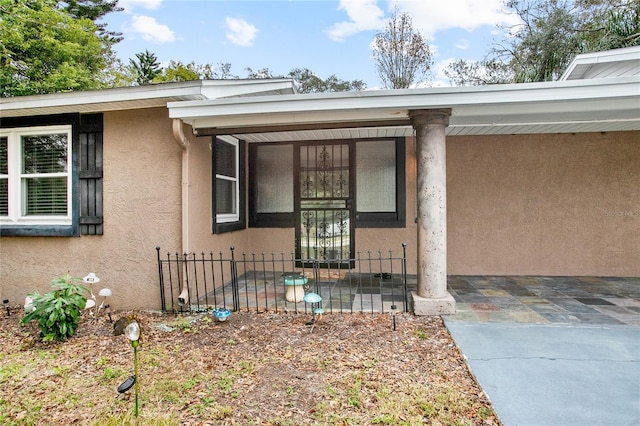 property entrance with a carport